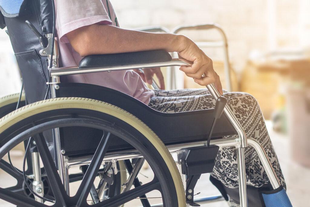 Paziente con la sclerosi multipla sulla sedia a rotelle.